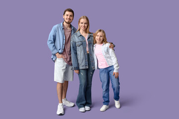Fototapeta premium Happy family in stylish denim clothes on purple background