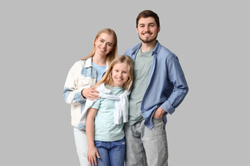 Happy family in stylish denim clothes on grey background