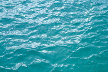 Ocean water surface. Water texture. Sea surface. Blue turquoise sea water background. Background of aqua sea water surface.