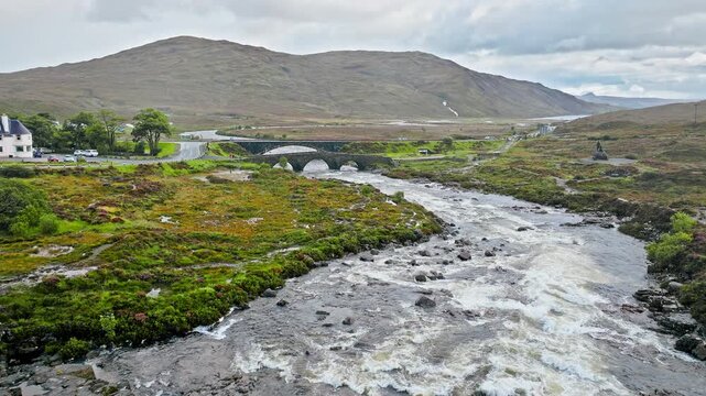 Aerial view of a curved old bridge, Tourist attraction in Scotland. Scottish Highlands Sligachan Old Bridge on the Isle of Skye.
