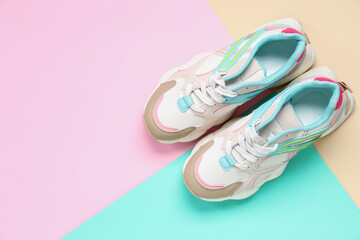 Pair of sneakers on colorful background. Top view