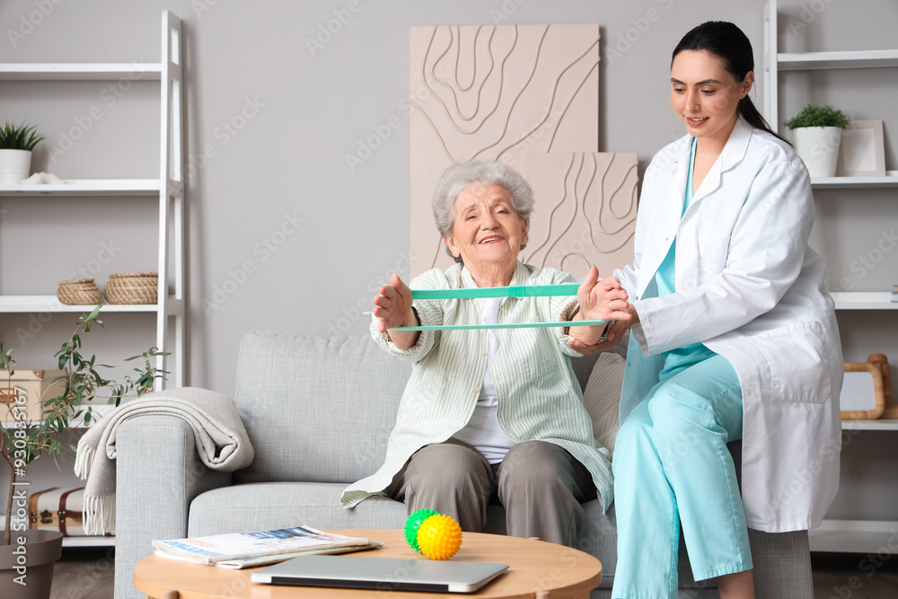 Canvas Prints senior woman with stretching band and physical therapist at home