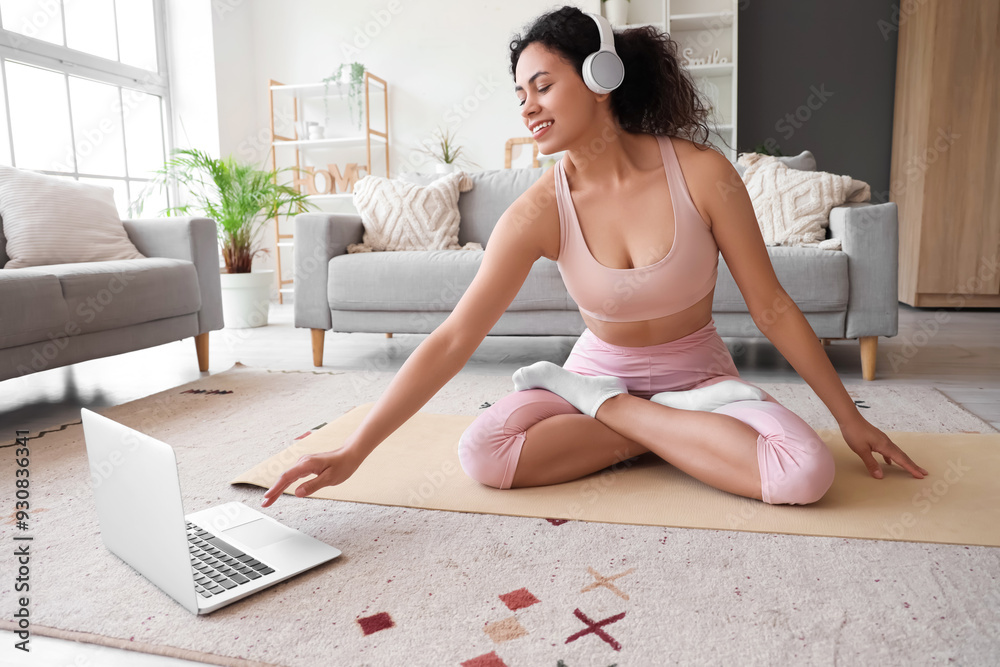 Canvas Prints sporty african-american woman video chatting with her online trainer on yoga mat at home