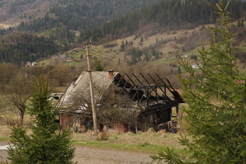 Ruins of a burned old house in the mountains of Ukraine