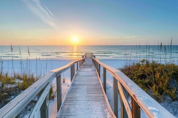 Obraz premium A serene beach pathway leading to a sunset over the ocean.