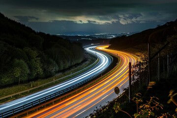 A long exposure shot capturing light trails on a winding road at night with a scenic backdrop.
