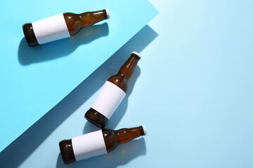 Bottles of cold beer on blue background