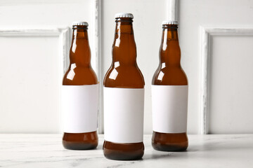 Bottles of cold beer on white background