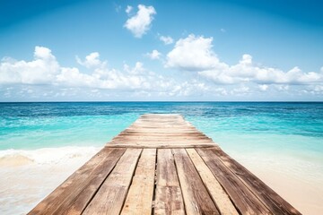 Wooden pier extending into turquoise ocean with white sand beach and clear water in a wide-angle view.
