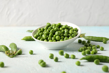 Bowl of green peas on light table