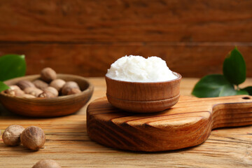 Bowl with shea butter on wooden table