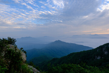 Misty clouds and mountains during sunrise