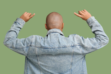 Bald young man on green background, back view