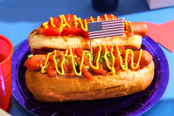 Tasty hot dogs with USA flag on blue background, closeup. American Independence Day celebration