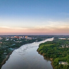 Border between Brazil and Paraguay and connects Foz do Iguacu to Ciudad del Este. Ponte da Amizade in Foz do Iguacu. Aerial view of the Friendship Bridge with Parana river.