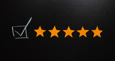 A chalkboard-themed image showcasing five vibrant orange stars alongside a hand-drawn checkmark...