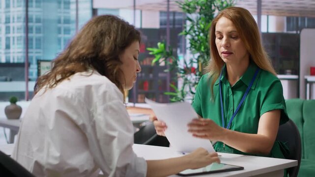 Human resources employees evaluating the job applications and CVs after the interviews, choosing the best candidate to fill in the corporate position. Selection process for employment. Camera A.
