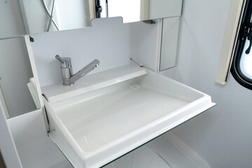 Interior with,tables,refrigerator,kitchen corners,ceiling ligthning,couches,living space in modern Slovenian camper van Adria.