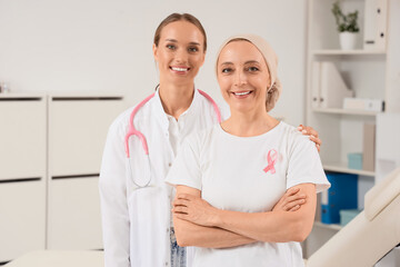 Obraz premium Smiling mature woman after chemotherapy with doctor in clinic