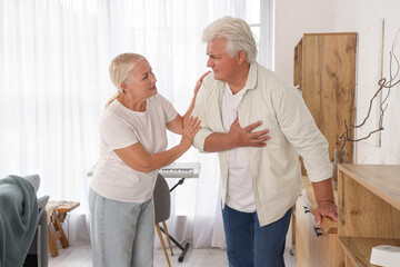 Mature man having heart attack with his wife at home