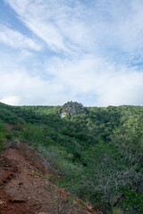 Road to the mountain. Arid mountains. Paths through the mountains with cacti and xeric vegetation. Red earth.