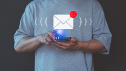 Adult man using a mobile phone receives a new email notification, highlighting the email and internet communication, data, digital marketing, e-mail icon technology and online networking concept.