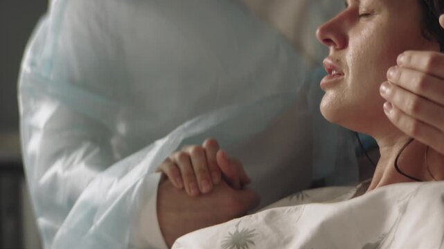 Midwife at the hospital during childbirth helping the woman