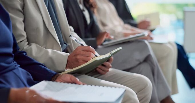 Business people, hands and writing with book in meeting, seminar or staff training at office. Closeup of person, row or line of trainees with notes on paperwork for presentation or audience together