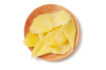Young mango kickshaw, made from thinly sliced tangy yellow mango, placed on a wooden dish, photographed with a white background.