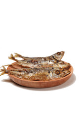 Fried Gereh Keranjang (pindang keranjang) fish, a traditional Indonesian side dish, served on a wooden plate and photographed with a white background.