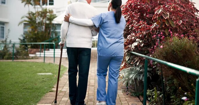 Back, caregiver and walking stick with senior patient for help, support and trust with care in garden. People, woman and pensioner with nurse in healthcare, rehabilitation and exercise on retirement