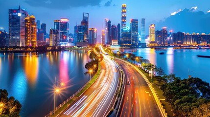 Obraz premium Stunning cityscape at night, showcasing vibrant lights, modern architecture, and a flowing river framed by a dynamic skyline.