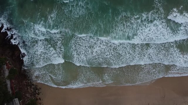 Aerial view of waves breaking on the Koh Mook or Ko Muk Charlie beach or Garnet Beach on windy day during the rainy season; drone video; Trang, Thailand