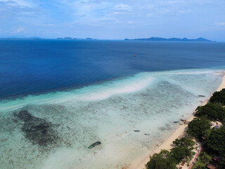 Aerial view of the Koh Kradan beach at low tide, with the coral reef on the surface and its turquoise waters, Trang, Thailand