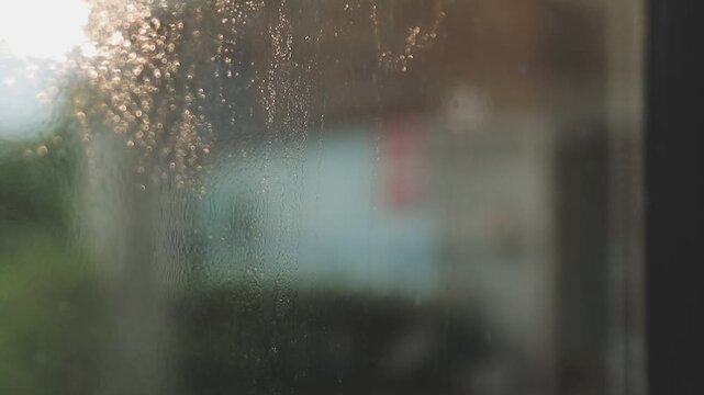 glass cleaner on a sheet of Cleaning glass window with a cloth special rag blue. close up hand