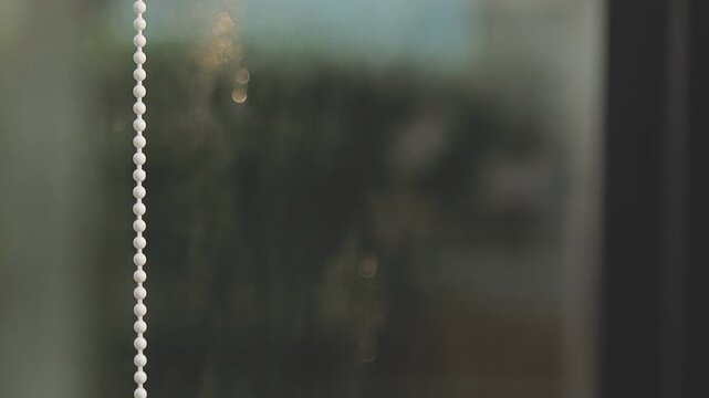 glass cleaner on a sheet of Cleaning glass window with a cloth special rag blue. close up hand