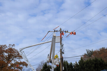Lineman electrician engineer use insulated equipment working climbing pole to maintain service on...