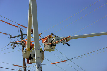 In order to maintains service on power line, lineman uses insulated equipment while climbing pole