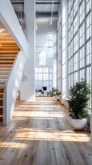 Obraz premium Sunlit modern office interior with soaring ceilings, expansive windows, and wooden floors, showcasing a blend of natural light and contemporary design elements.