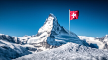 Swiss Flag on Snowy Mountain Peak with Majestic Matterhorn in Background on a Clear Blue Sky Day