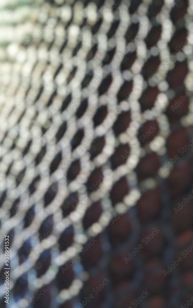 Wall mural a highly blurred abstract pattern of luminous hexagons and dark spaces creates a soft, dreamy bokeh 