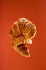 conceptual photo of fresh croissant on warm background and copy space 