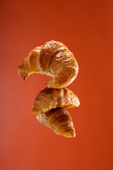 conceptual photo of fresh croissant on warm background and copy space 