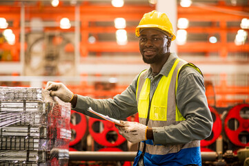 Portrait of happy maintenance worker with confident service at factory warehouse.