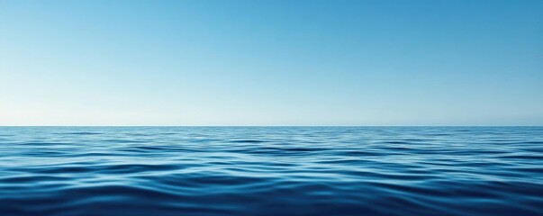 Fototapeta premium A serene view of the calm ocean under a clear blue sky, perfect for conveying tranquility and peacefulness.