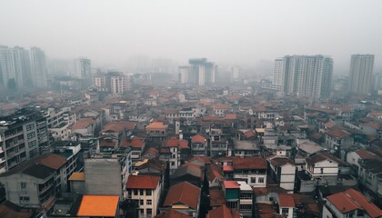 Obraz premium An aerial view of a city with a layer of fine dust covering rooftops, emphasizing the widespread nature of air pollution