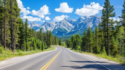 Fototapeta premium A scenic road winds through lush trees, with majestic mountains and a clear blue sky in the background, perfect for travel inspiration.