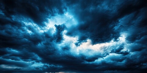 Dramatic storm clouds dominate the sky, with deep blue hues contrasting against lighter shades, creating a moody atmosphere.