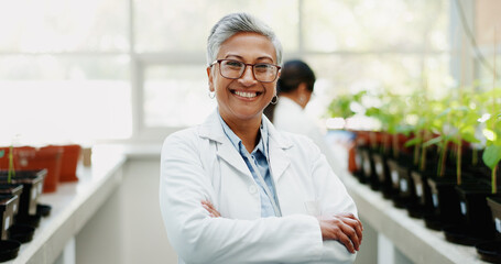Woman, scientist and arms crossed in greenhouse for portrait with smile, pride and research for...