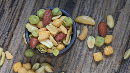 Mixed Nuts With Rice Crackers Roasted and Salted in coconut shell bowl